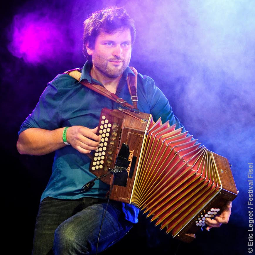 Martin Coudroy playing accordion on stage